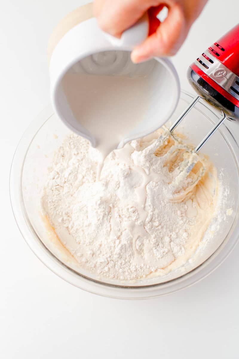 pouring in the sour cream and milk mixture to the cupcake batter.