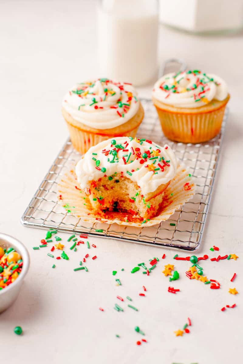 closeup of three Christmas Cupcakes on a wire rack.
