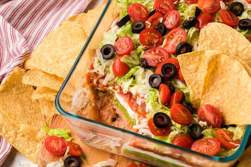 top-down view of the 7 Layer Dip with a scoop served out of it.