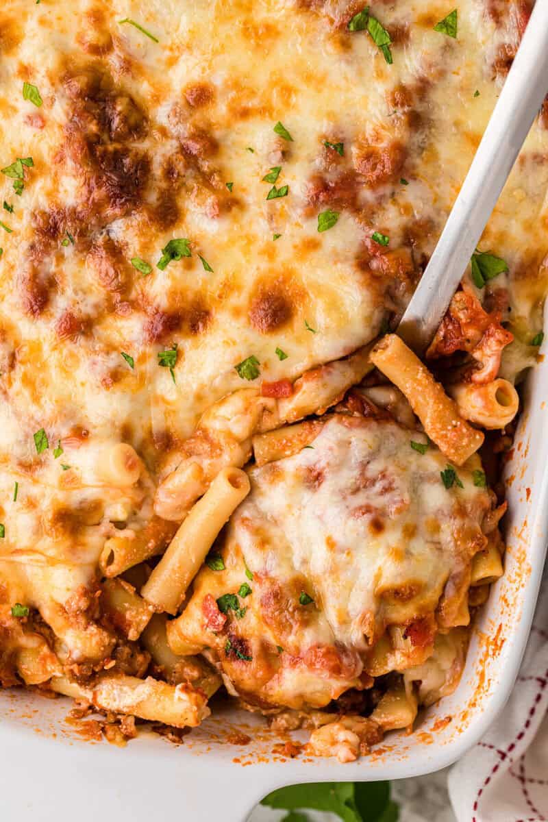 closeup of serving the Baked Ziti out of the baking dish.