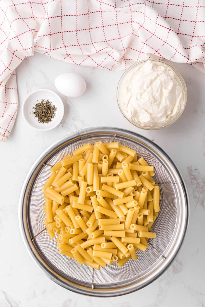 cooked ziti pasta in a colander. 