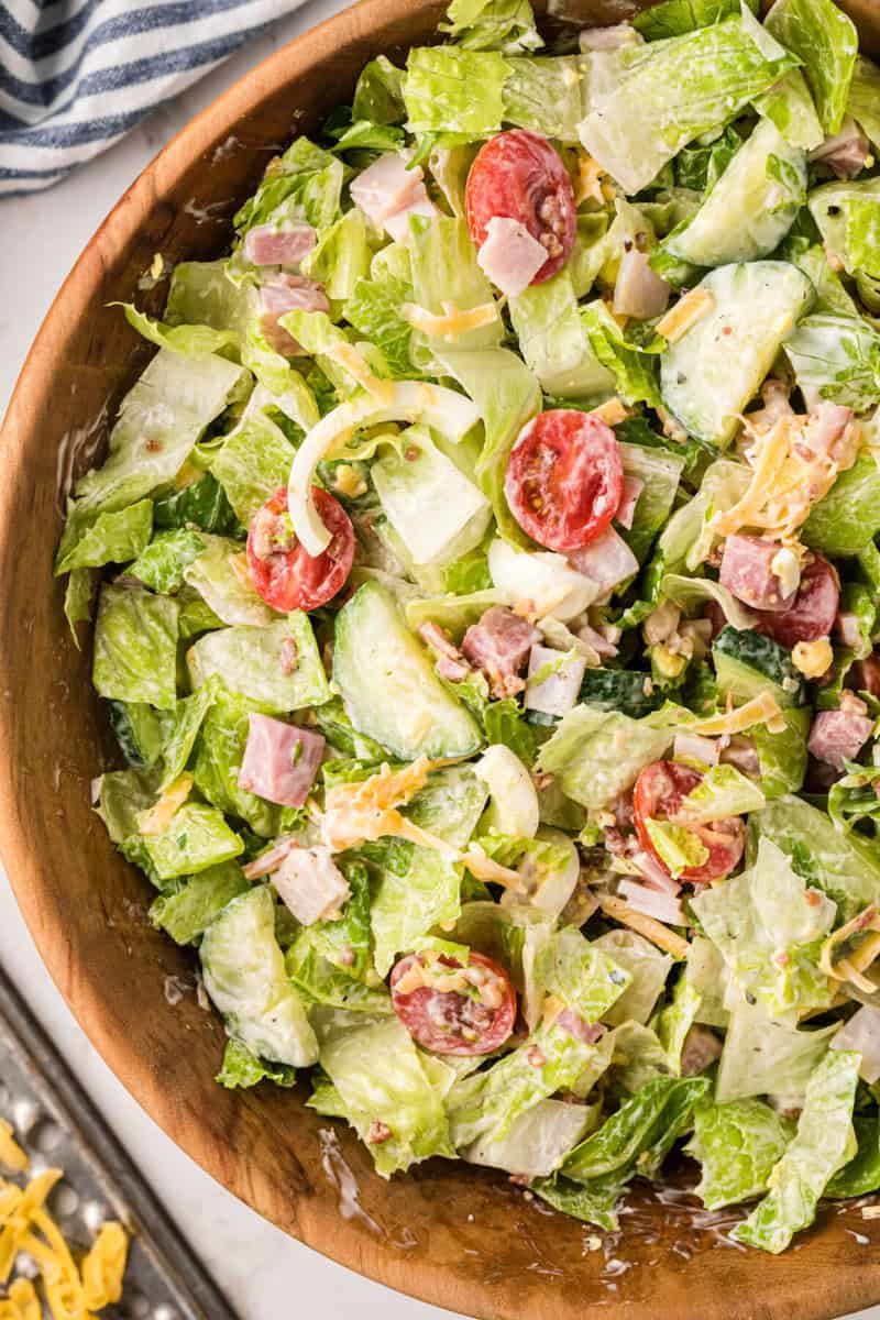 tossed Chef salad in wooden bowl.