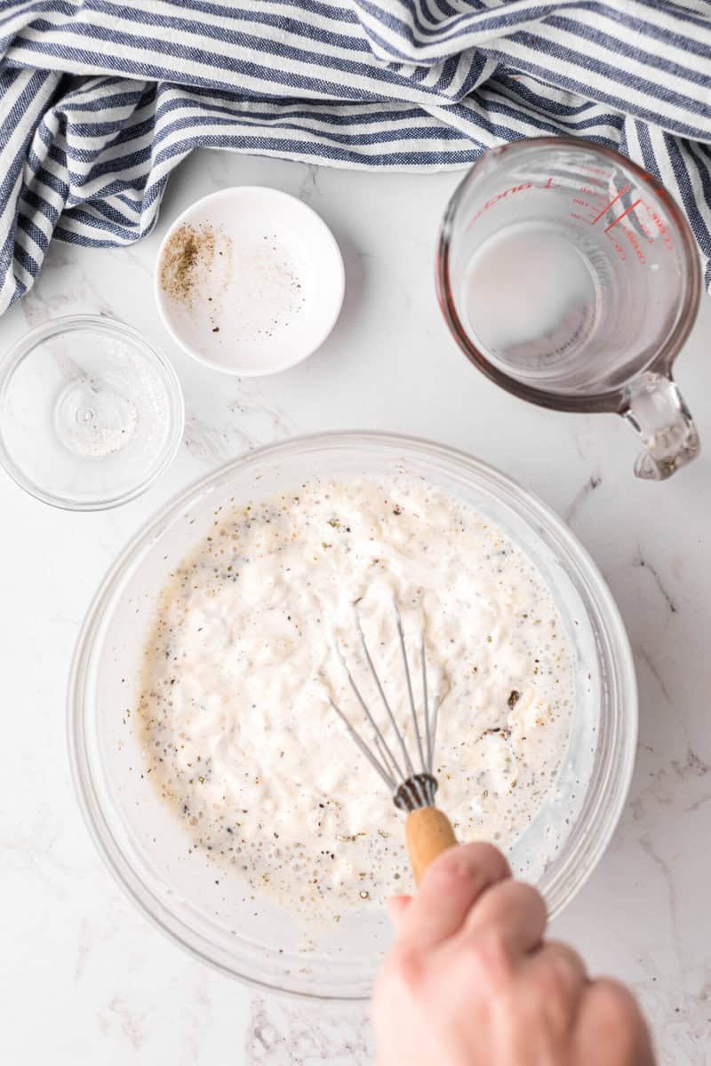 mixing the ingredients together for the ranch dressing.