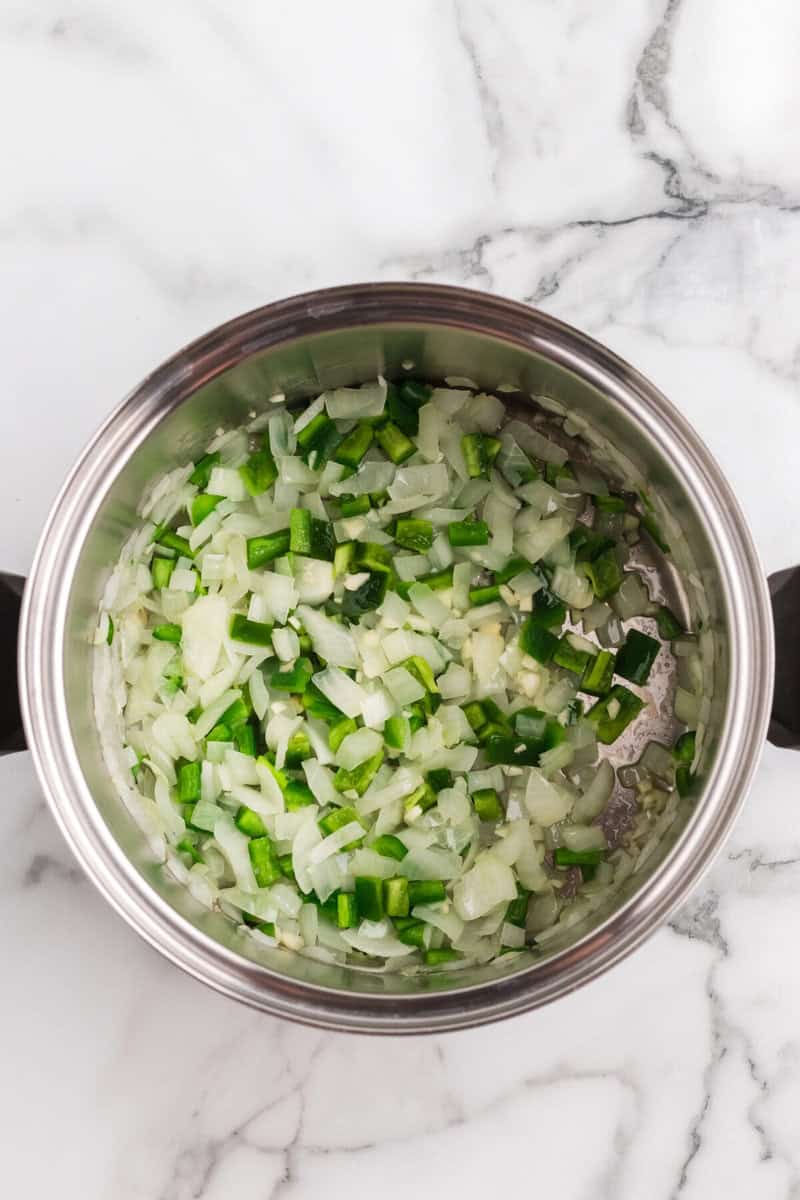 adding the diced jalapenos to the onions.