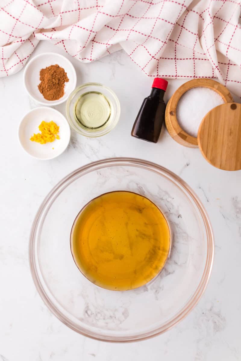 mixing together the honey sauce for the granola.