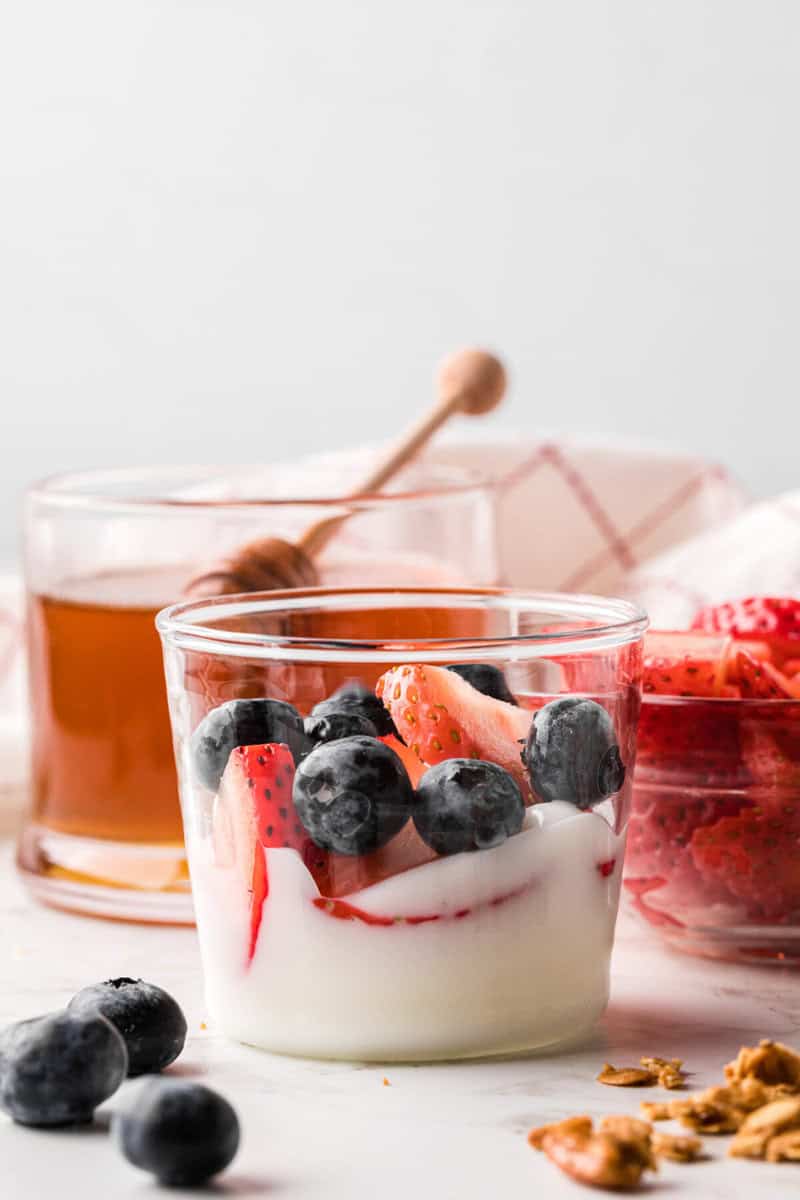building the parfait in a clear cup.