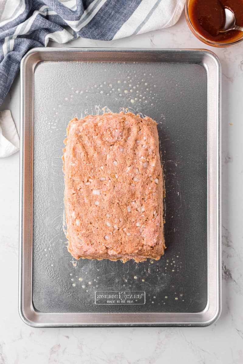 meatloaf formed into loaf on the baking sheet before baking.