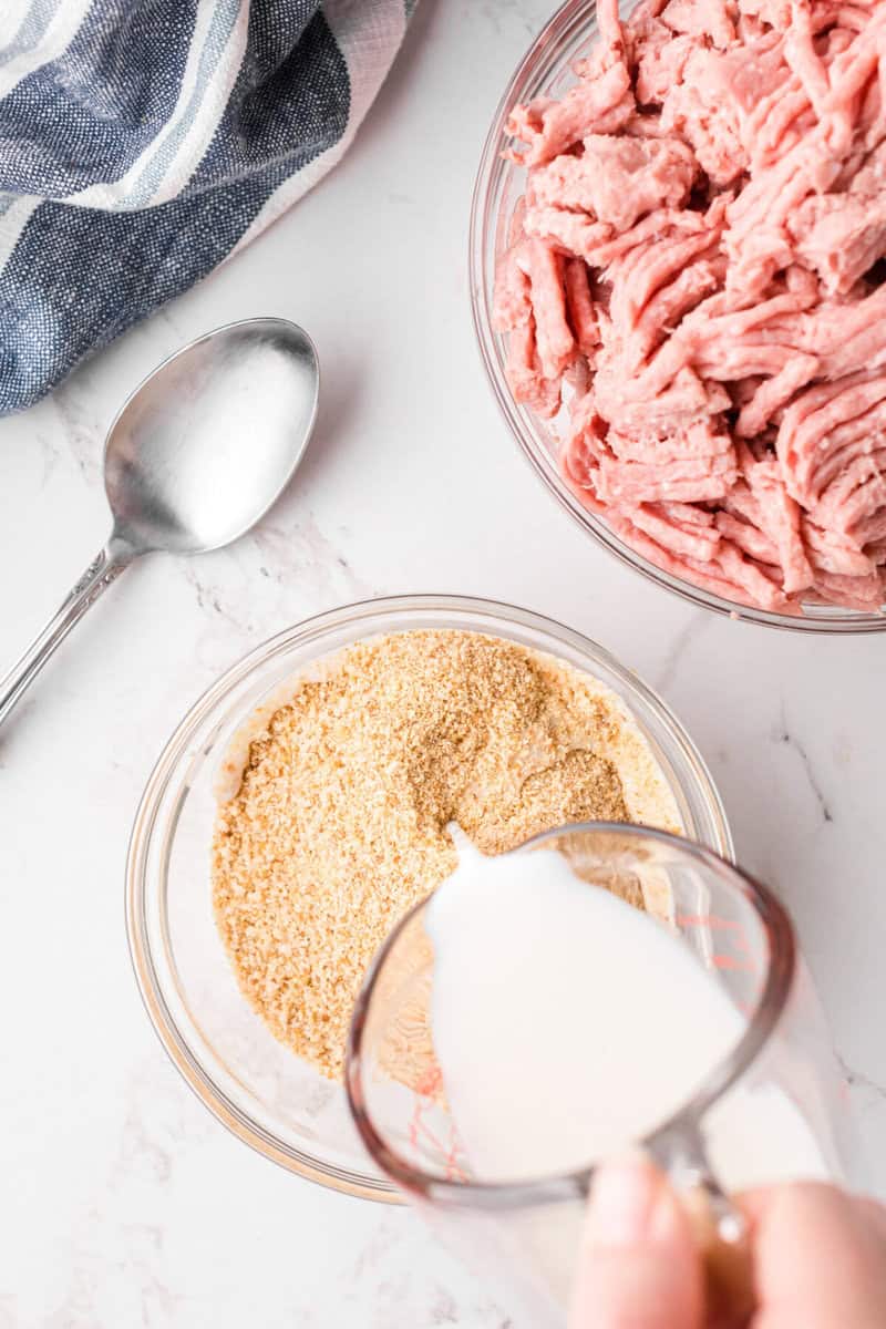 adding milk to the breadcrumbs.