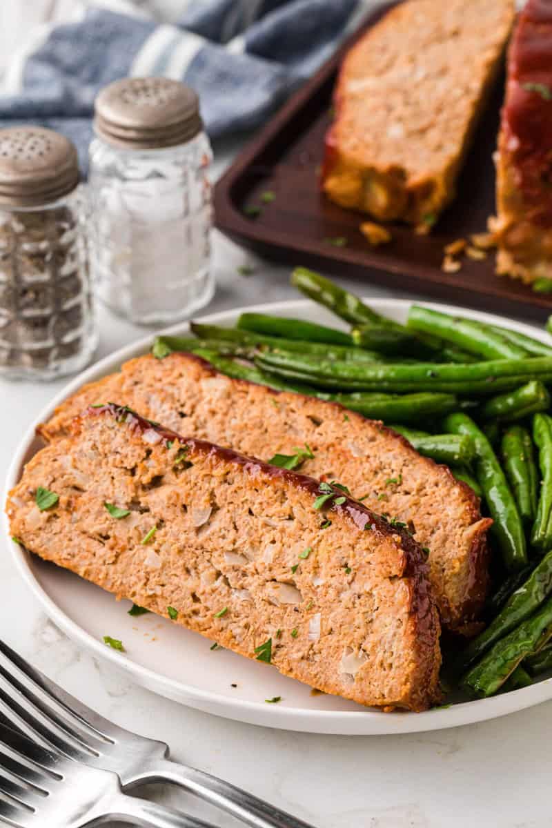 two slices of the turkey meatloaf of white plate.