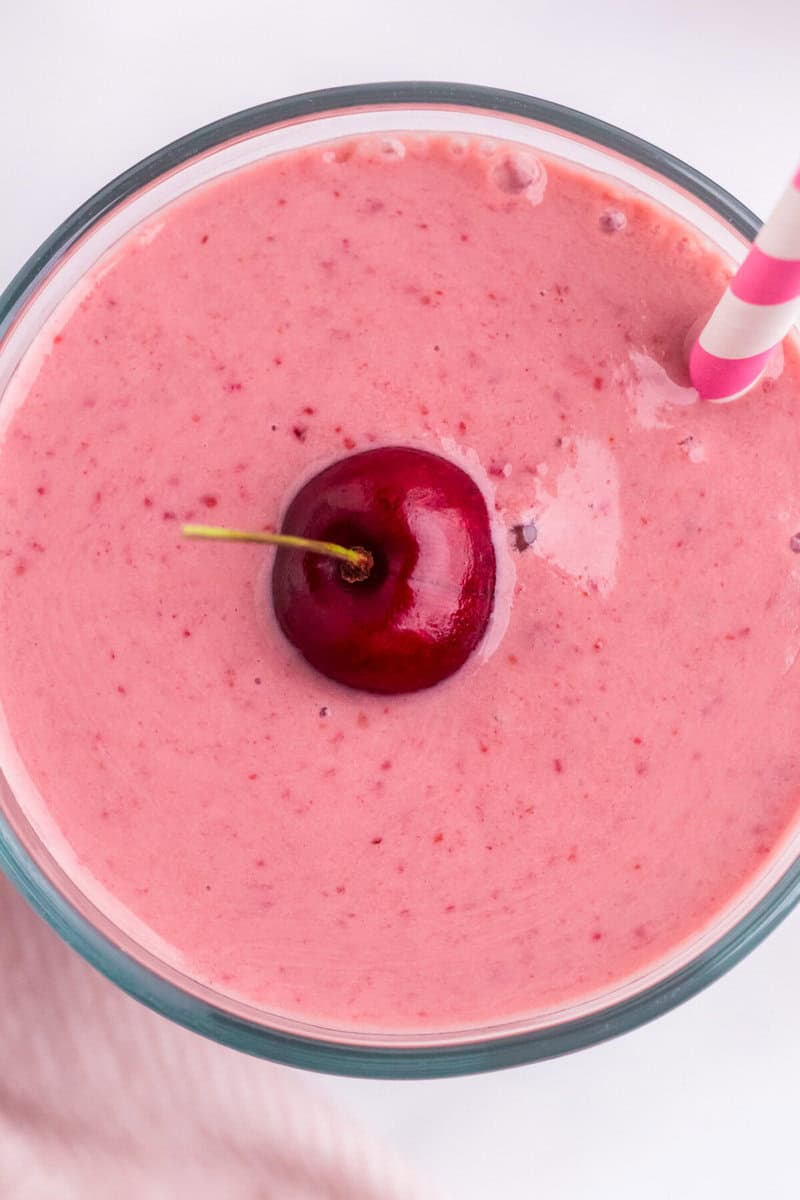 closeup top-down view of a glass of the cherry smoothie.