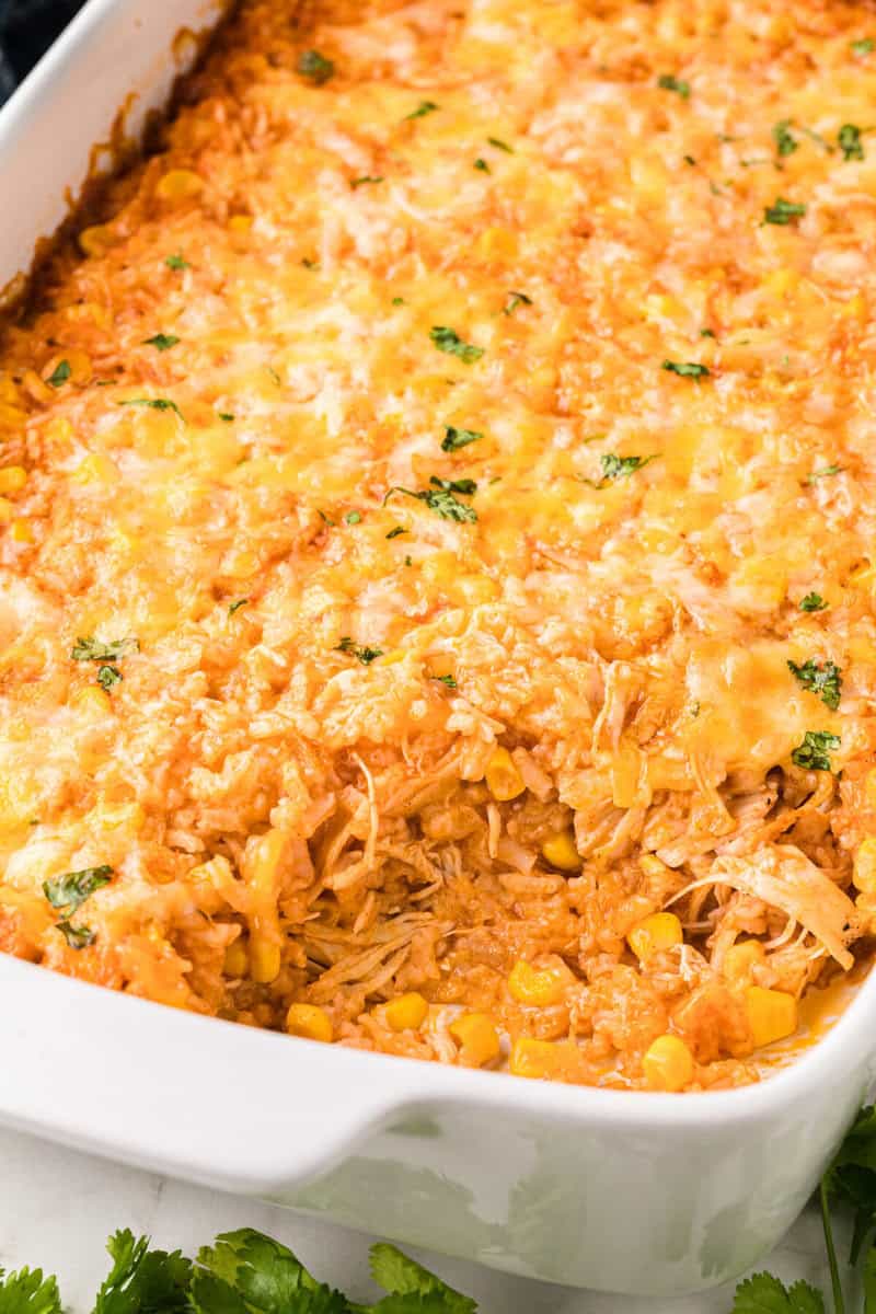 closeup of the baked chicken enchilada casserole in the baking dish.