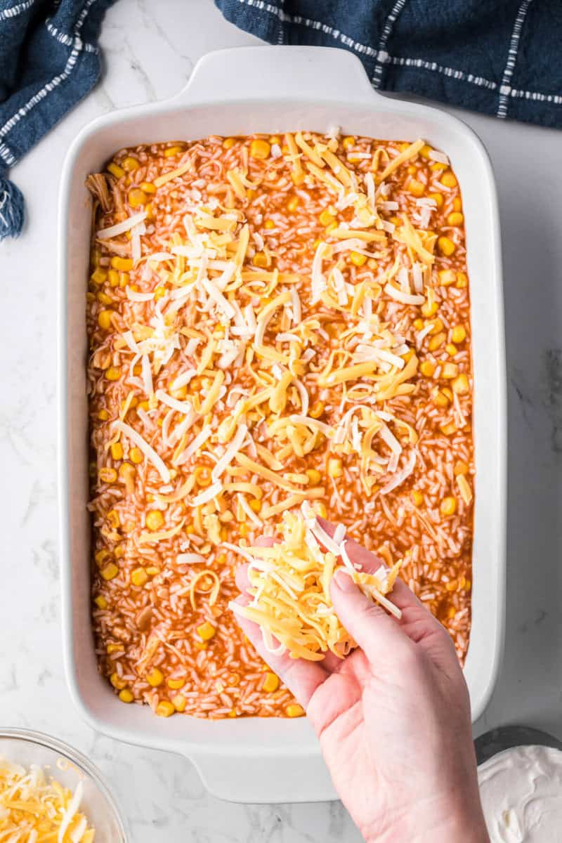 sprinkling cheese on top of the casserole before baking.