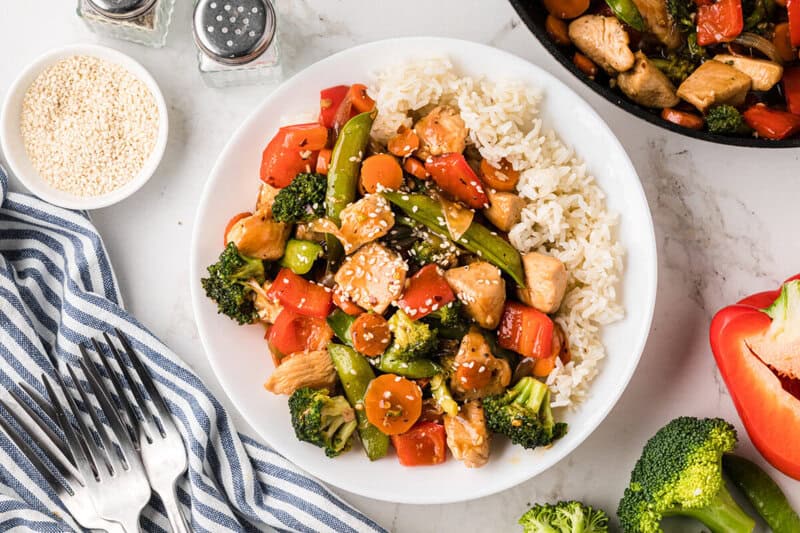 Chicken Stir Fry served on a white plate with rice.