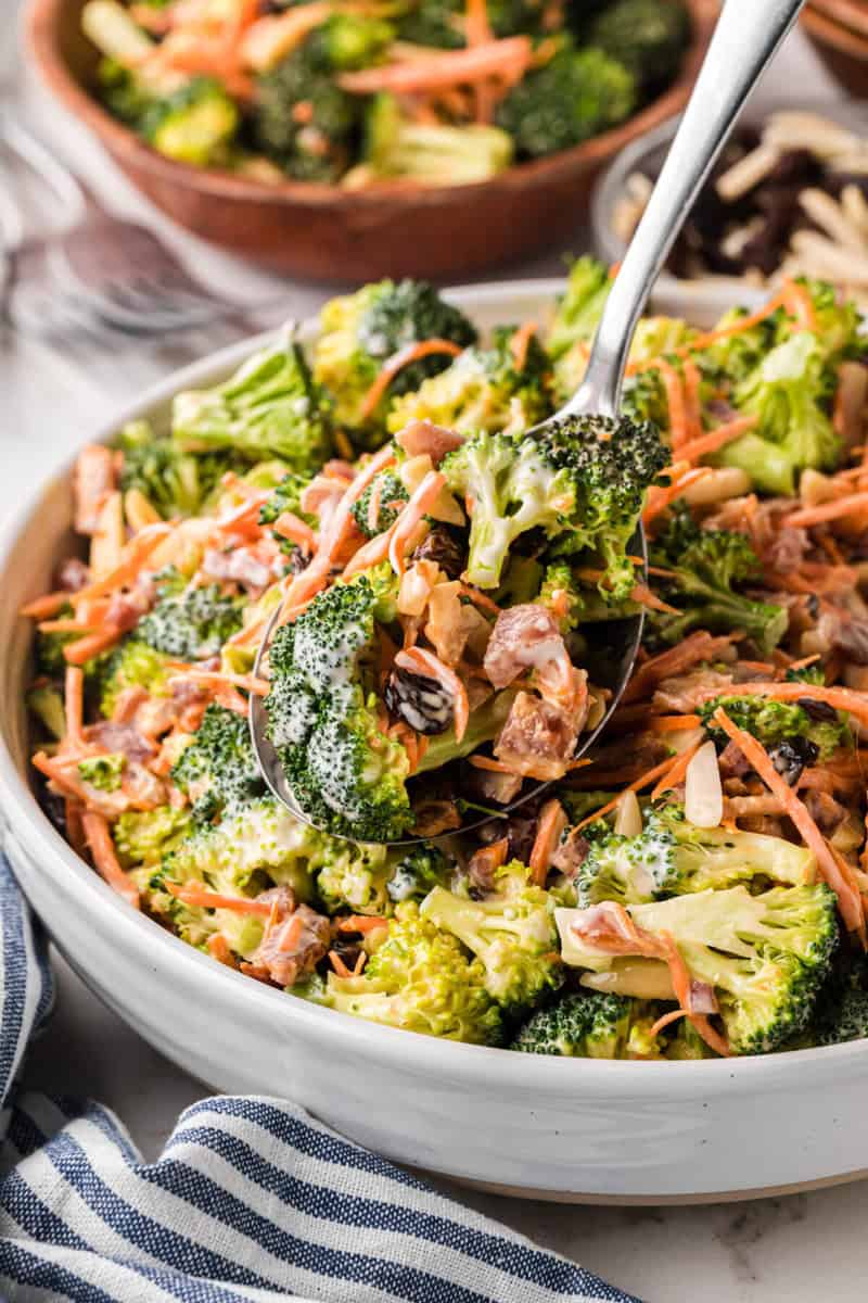 closeup of the broccoli salad served with a metal spoon.