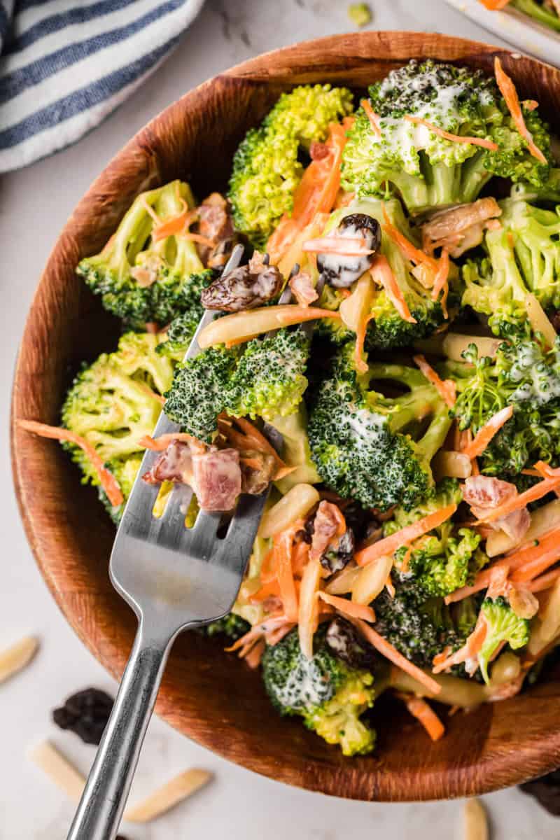 top-down closeup of the Broccoli Salad in a wooden bowl.