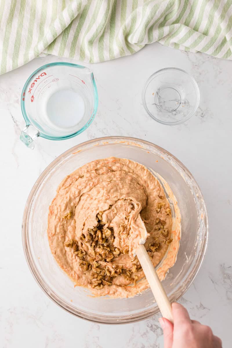 mixing the walnuts into the cupcake batter.