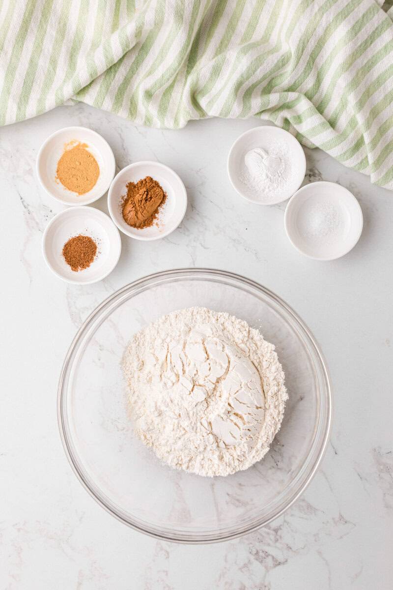 adding the dry ingredients for the cupcakes in a large glass bowl.