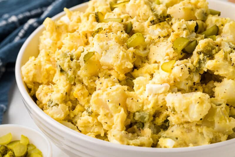 closeup of the potato salad in a white serving bowl.