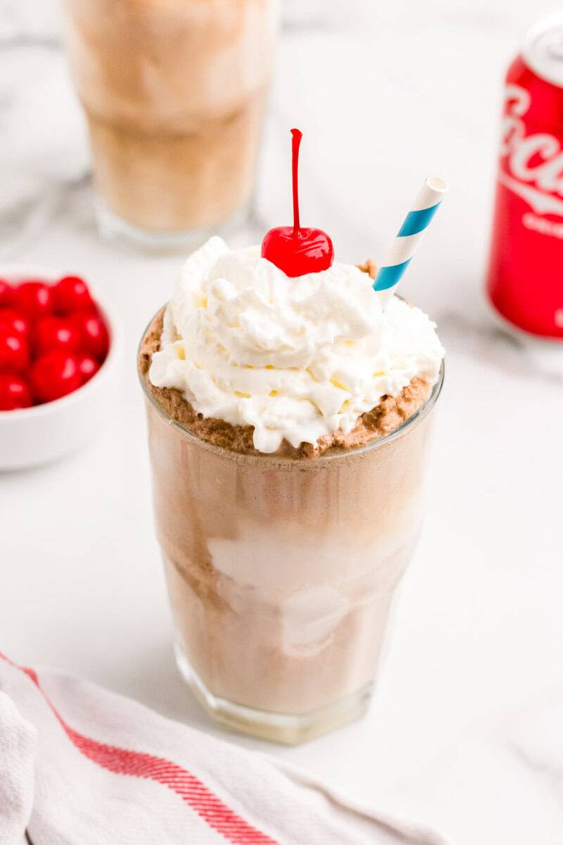 closeup of the Coke Float with whipped cream and a cherry.