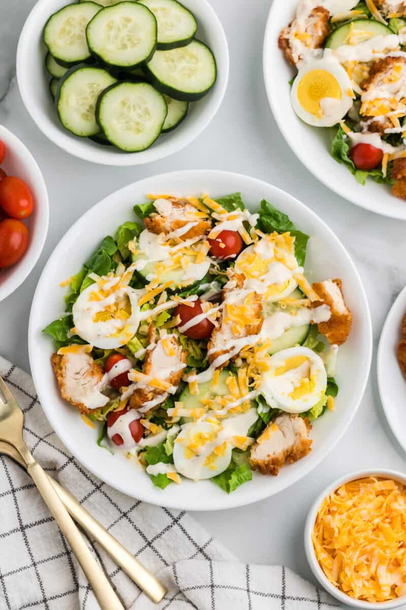 top-down view of the crispy chicken salad drizzled with the ranch dressing.