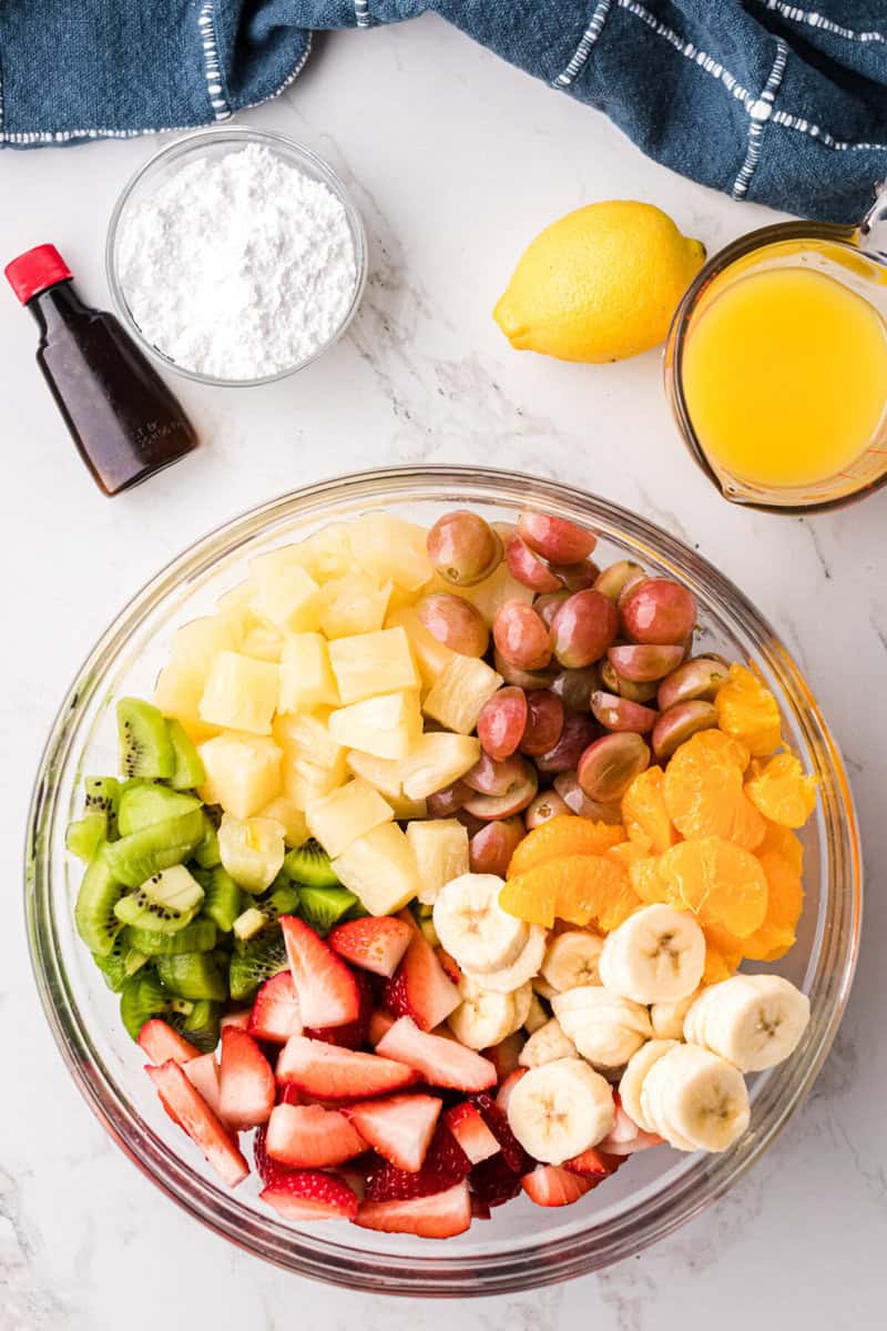 adding the fruit to a large bowl for mixing and serving.