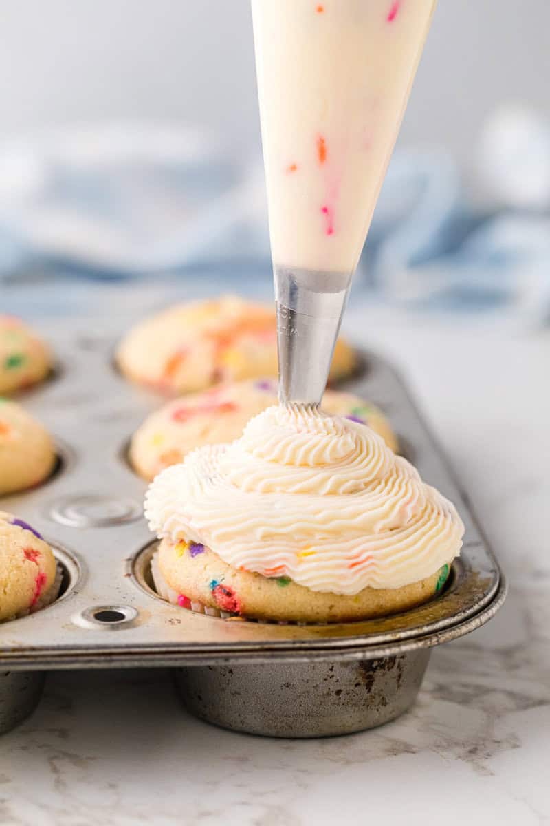 frosting the Funfetti Cupcakes in the pan.