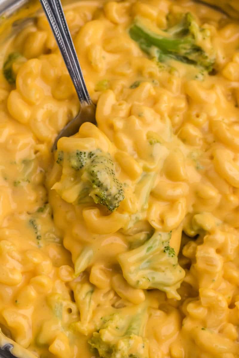 closeup of the Broccoli Mac and Cheese with a metal fork in it.