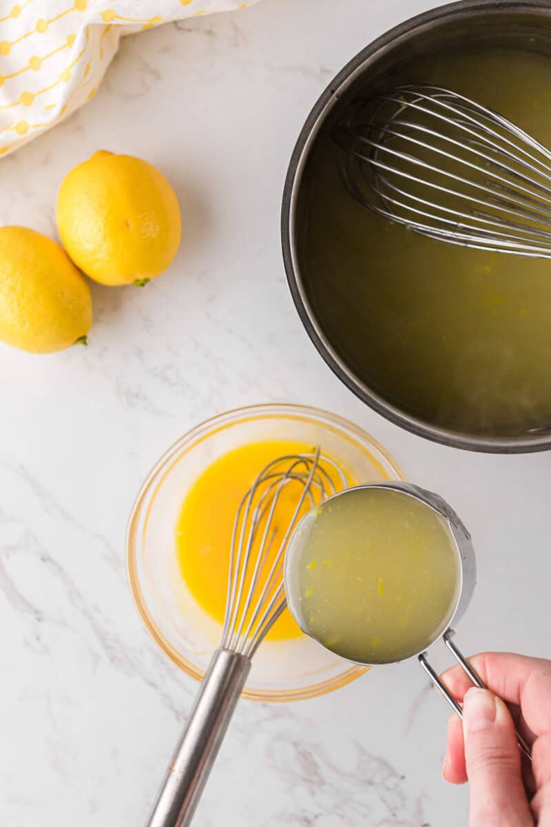whisking together the hot lemon juice with the egg yolks.