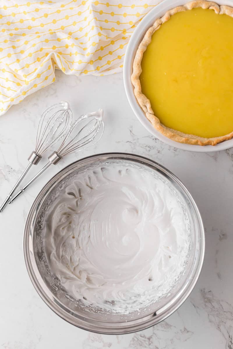 Meringue whipped together in a metal bowl.