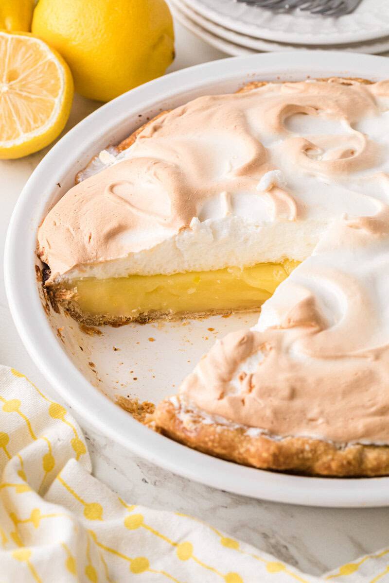 Lemon Meringue Pie in pie pan with a slice taken out of it.