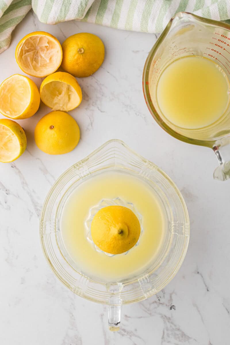 squeezing the lemons to get the juice.