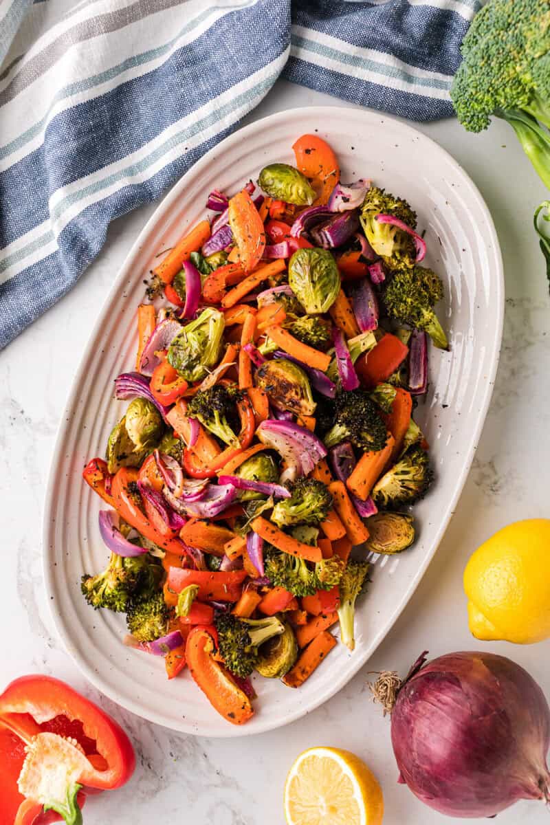 top-down view of the roasted vegetables served on white serving tray.