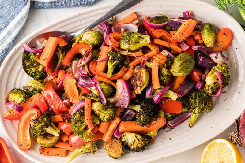 top-down view of the roasted vegetables served on a white tray.