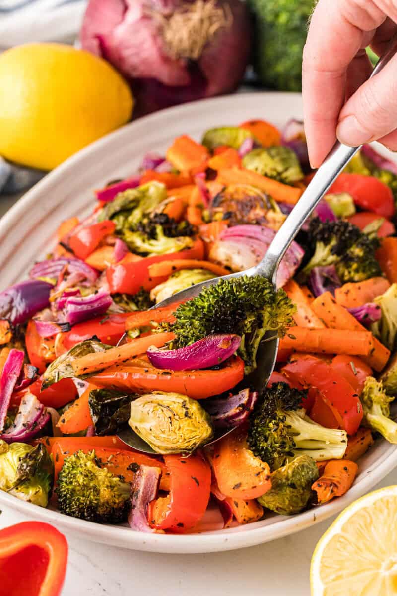 serving the roasted vegetables with a metal spoon.