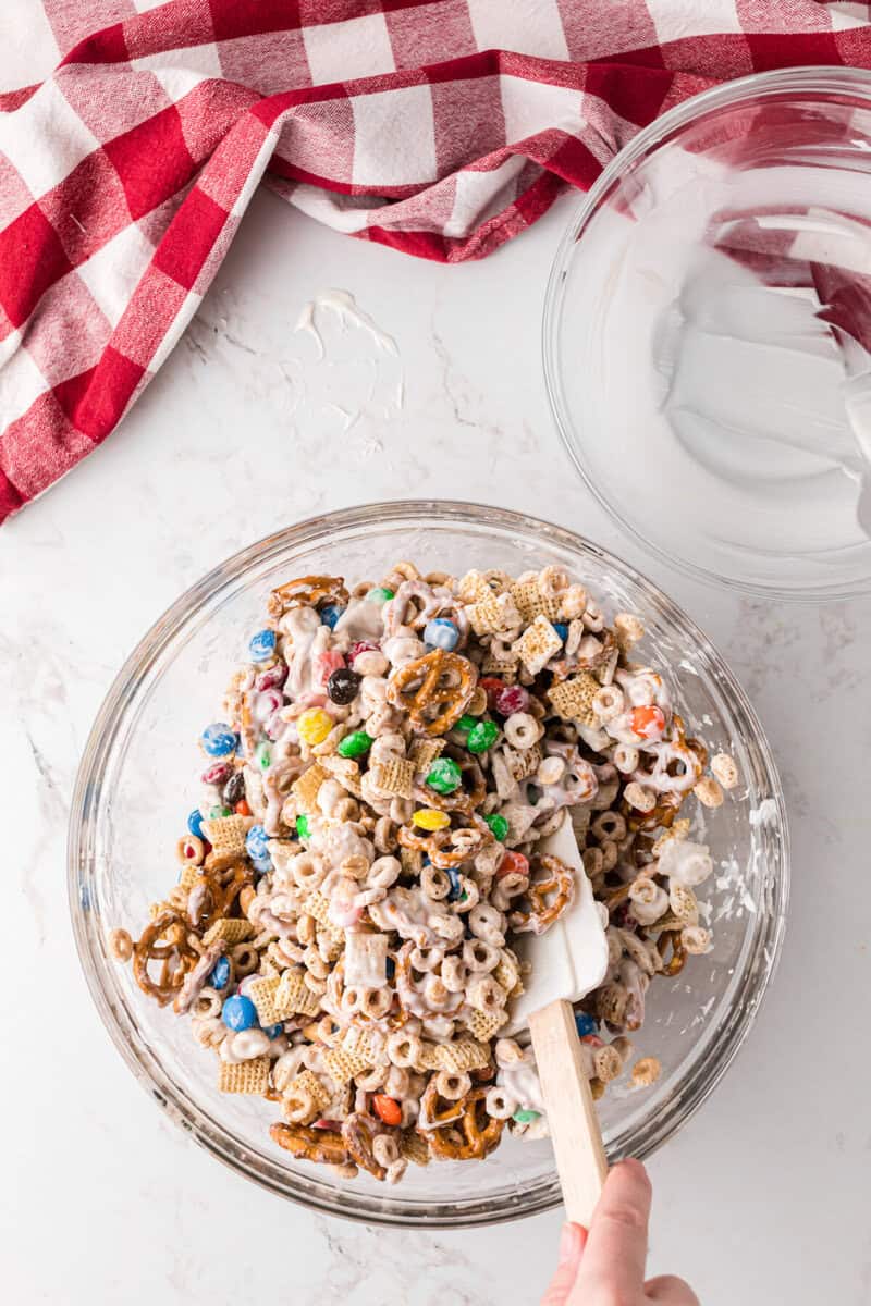 mixing the ingredients together with the almond bark.