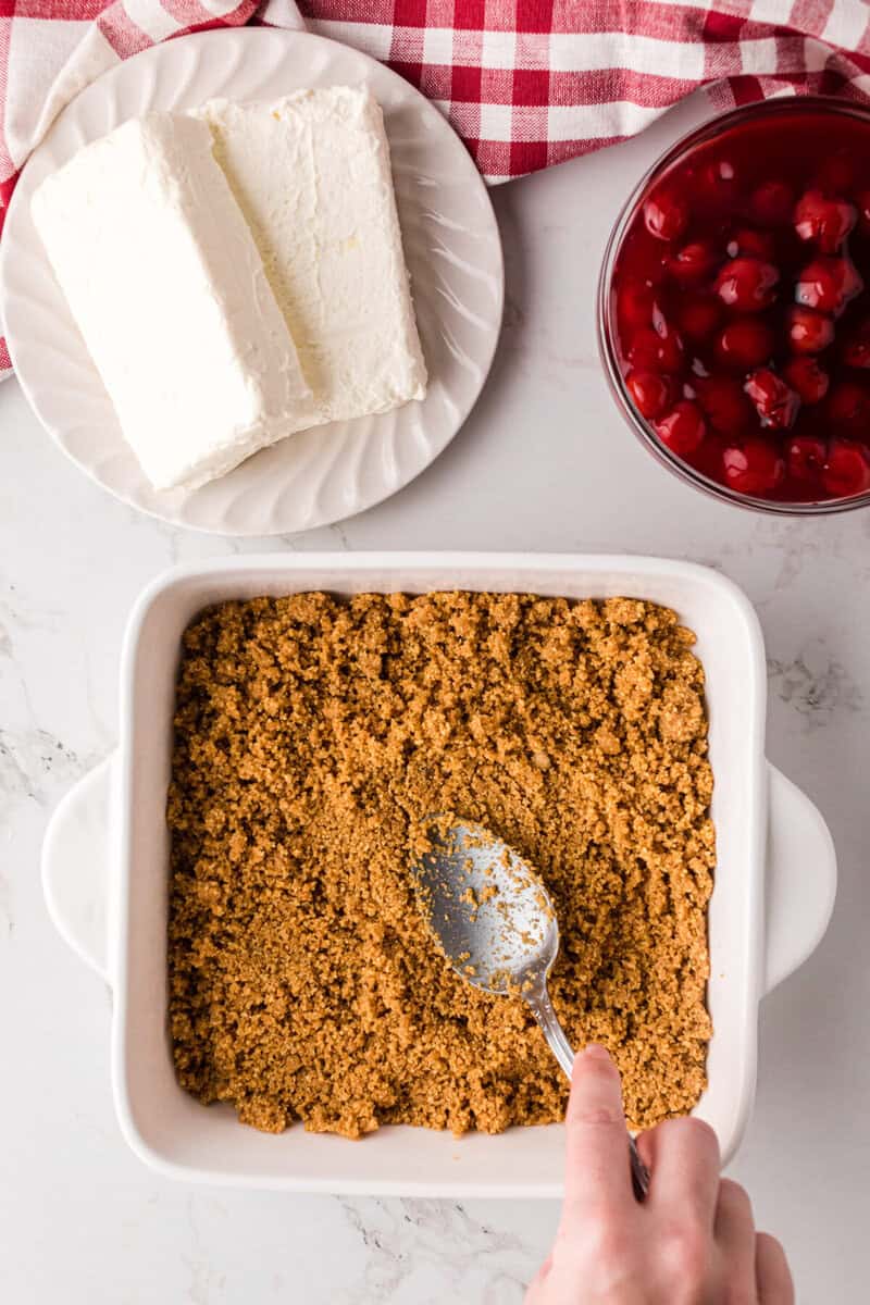 spreading crust onto the bottom of the dish.