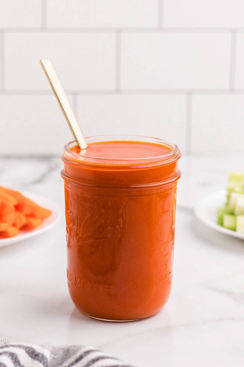 mason jar full of homemade buffalo sauce.