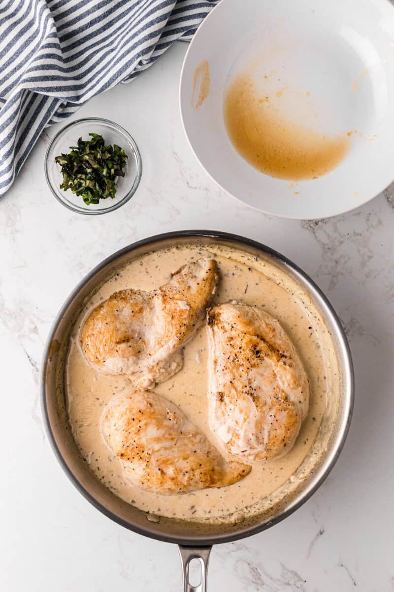 adding the chicken to the cream sauce.