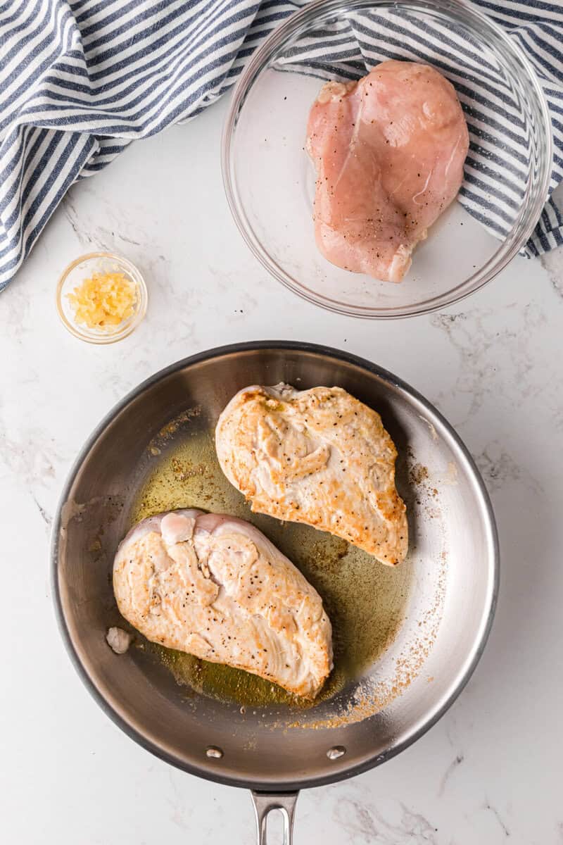 cooking the chicken in a skillet.