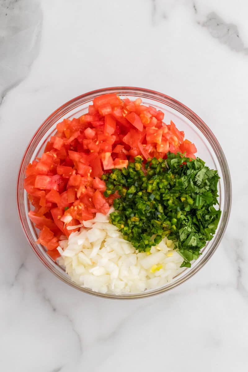 ingredients for the Pico de Gallo in a large clear bowl.