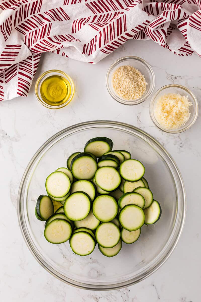Zucchini in a mixing bowl to mix with oil, Parmesan Cheese, and breadcrumbs.