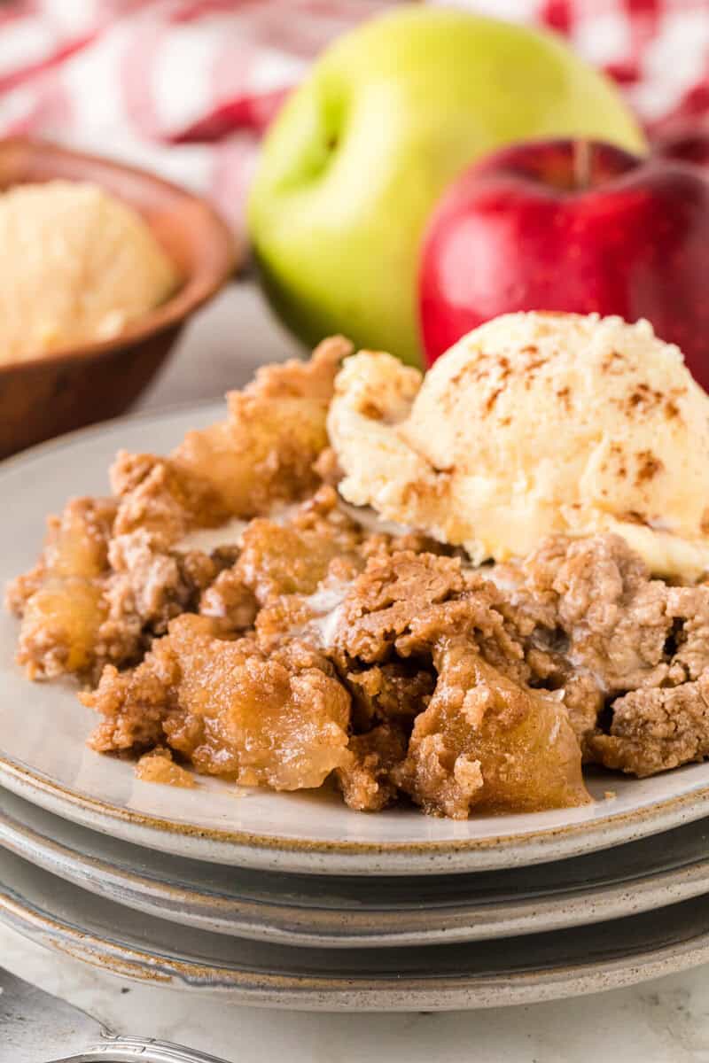 closeup of the Apple Spice Dump Cake on stacked white plates.