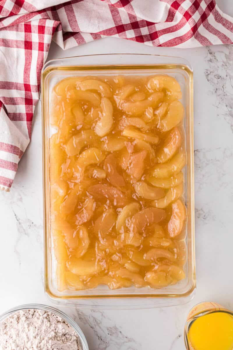 apple pie filling on the bottom of the baking dish.