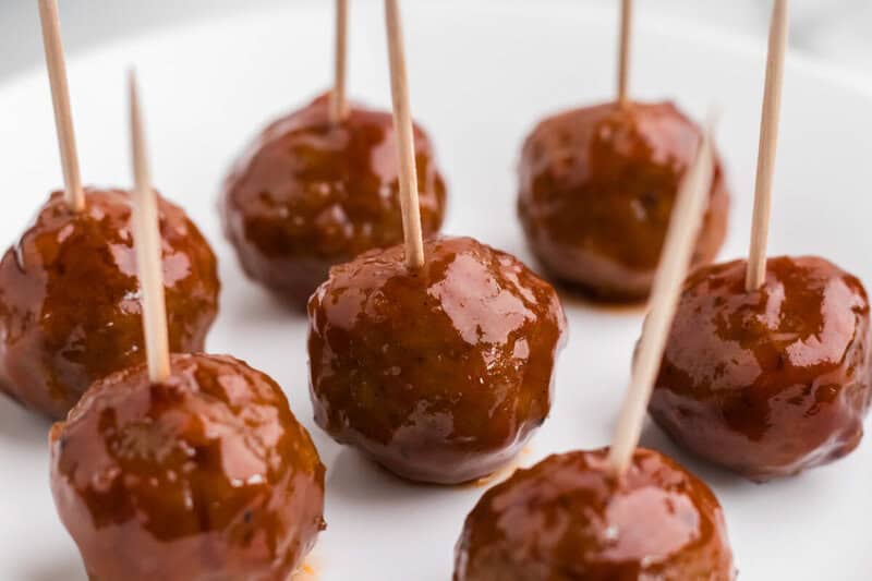 closeup of the meatballs on a plate with toothpicks in them.