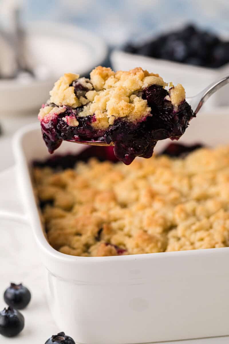 serving the cobbler with a metal spoon.