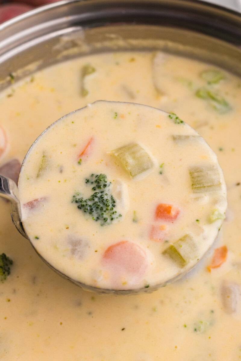 closeup of the soup being served with a ladle.