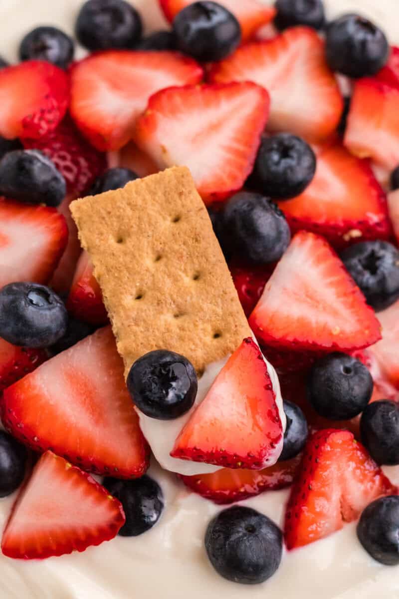 closeup of using a graham cracker to eat the dip.