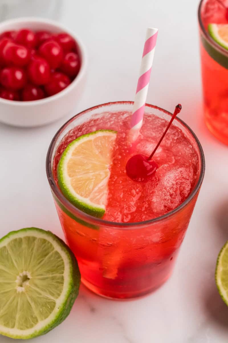 glass of the Cherry Limeade with a slice of lime in it.