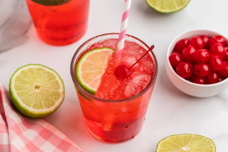 glass of the Cherry Limeade with a slice of lime in it.