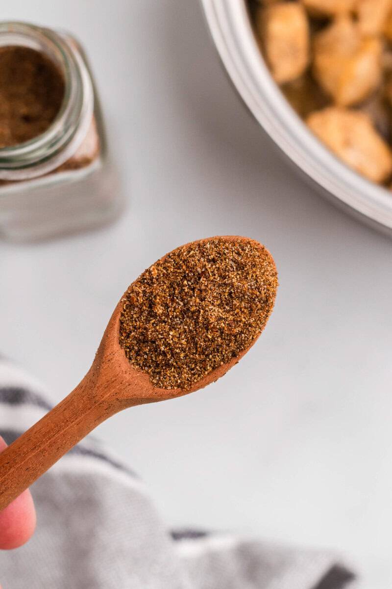 homemade taco seasoning on a wooden spoon.
